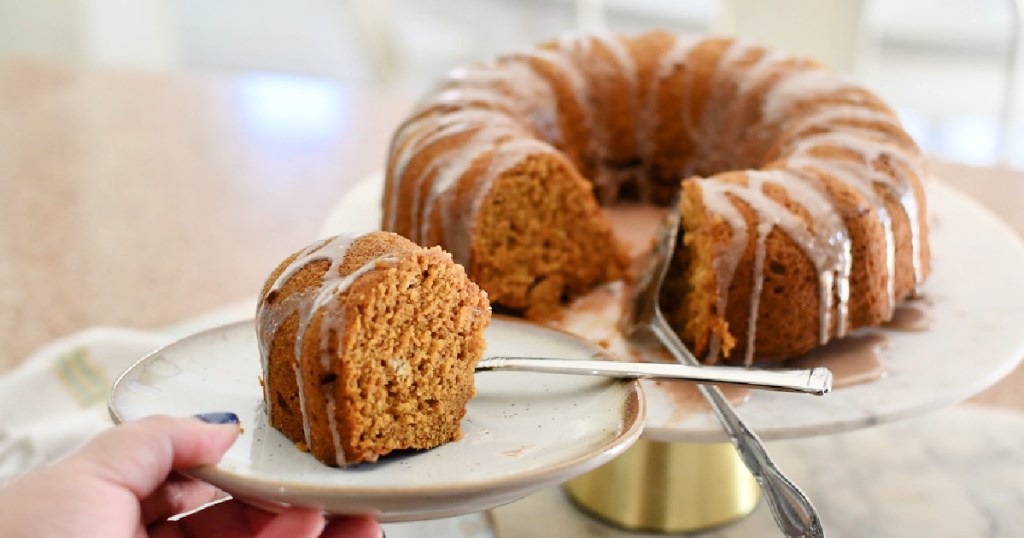 holding a plate with pumpkin bundt cake