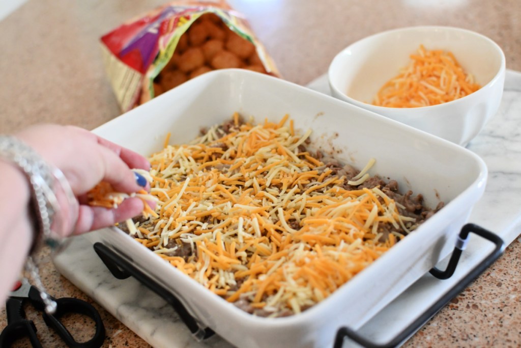adding cheese to tater tot casserole before the tots