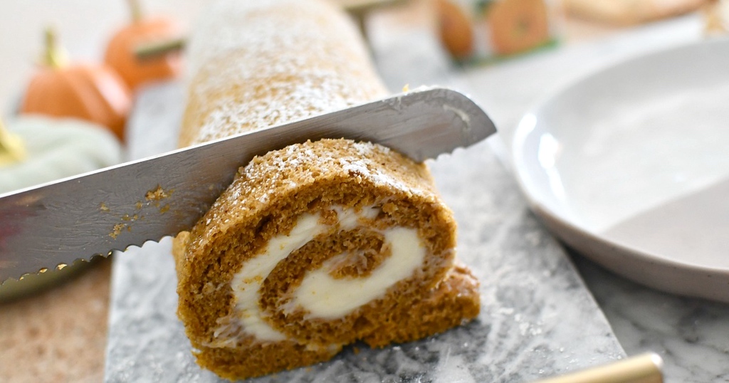 slicing into pumpkin roll 