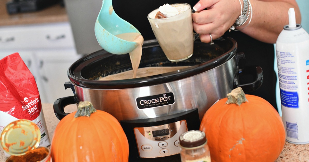pouring a cup of slow cooker pumpkin latte