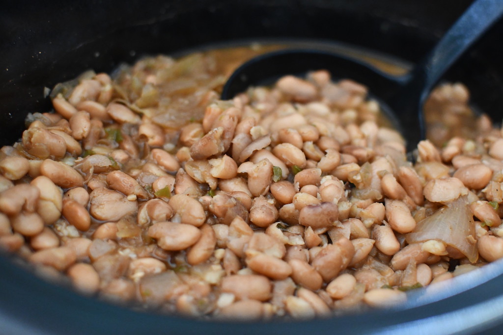 beans in slow cooker with ladel 