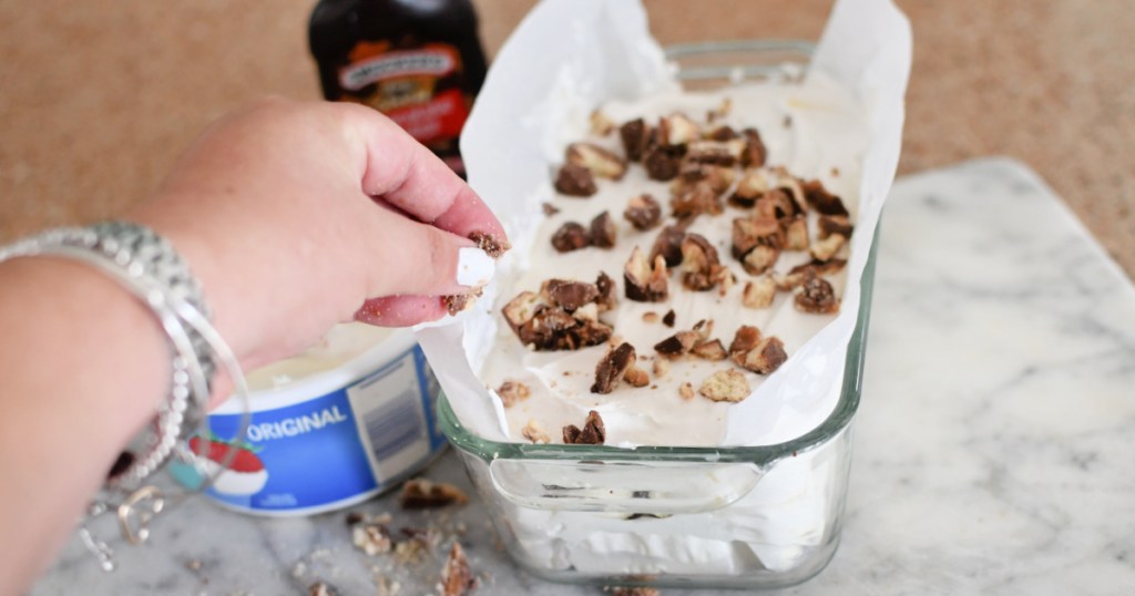 adding chopped Twix to ice cream sandwich cake