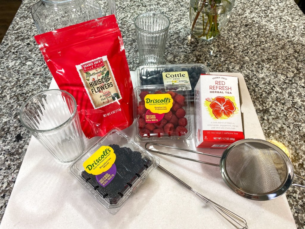 ingredients for a berry tea drink on kitchen counter