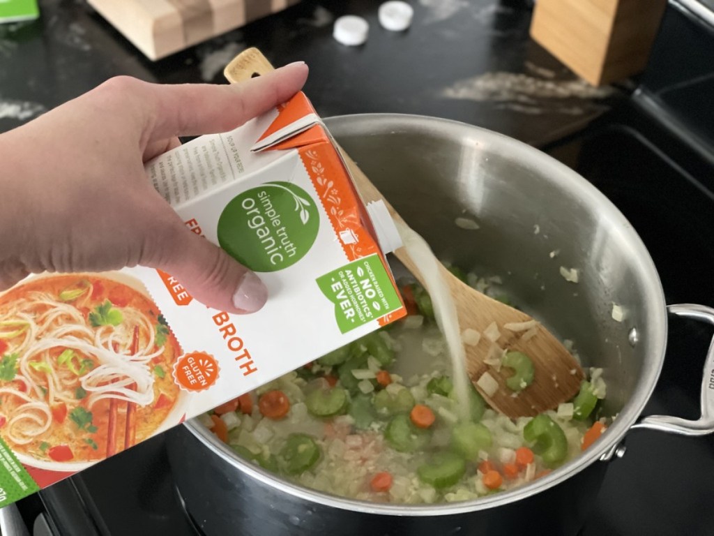 pouring broth into large stockpot