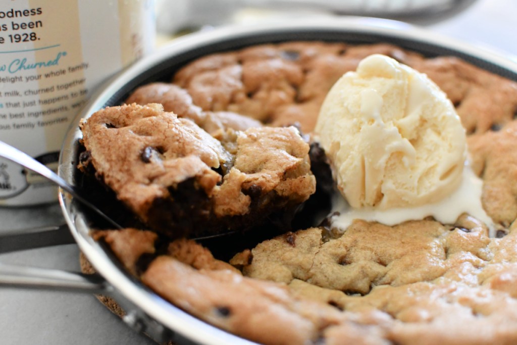 scooping up chocolate chip skillet cookie
