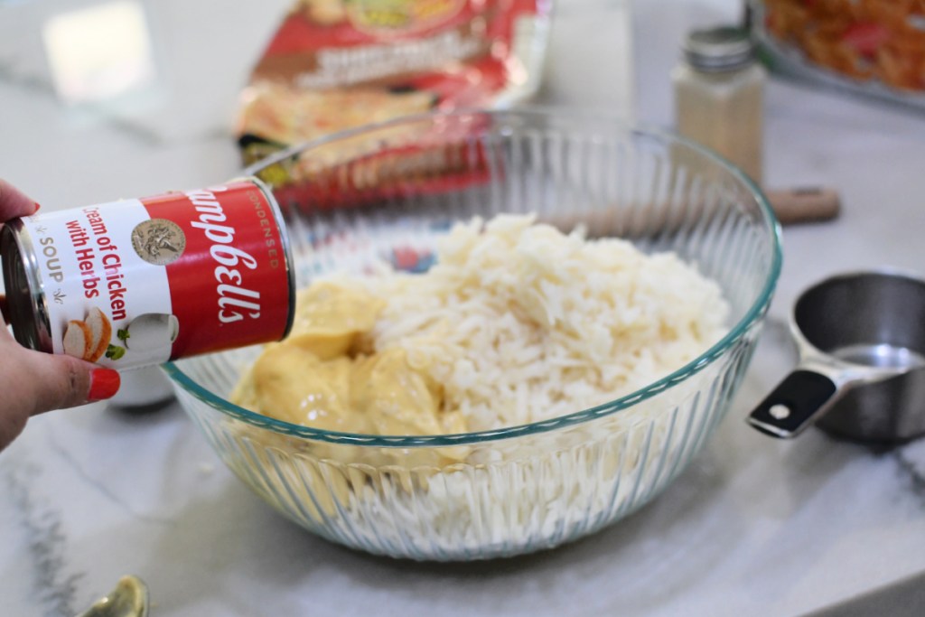 adding cream of mushroom soup to funeral potatoes