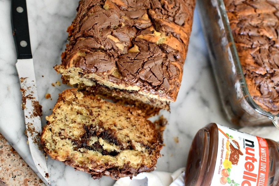 cutting a loaf of nutella banana bread