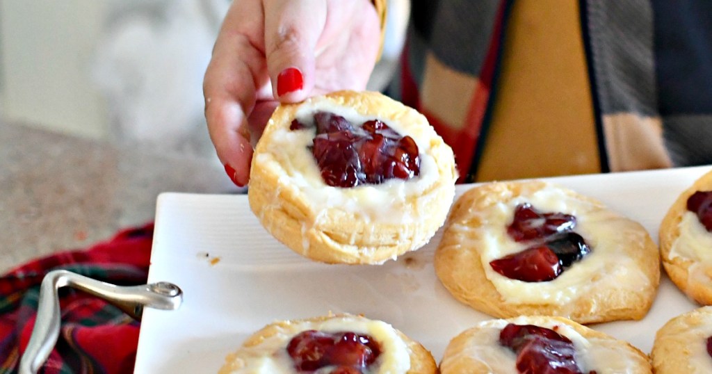 holding up a cherry cheese danish