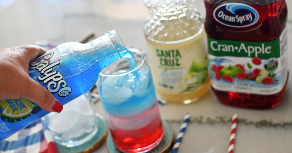 pouring blue lemonade into a mocktail