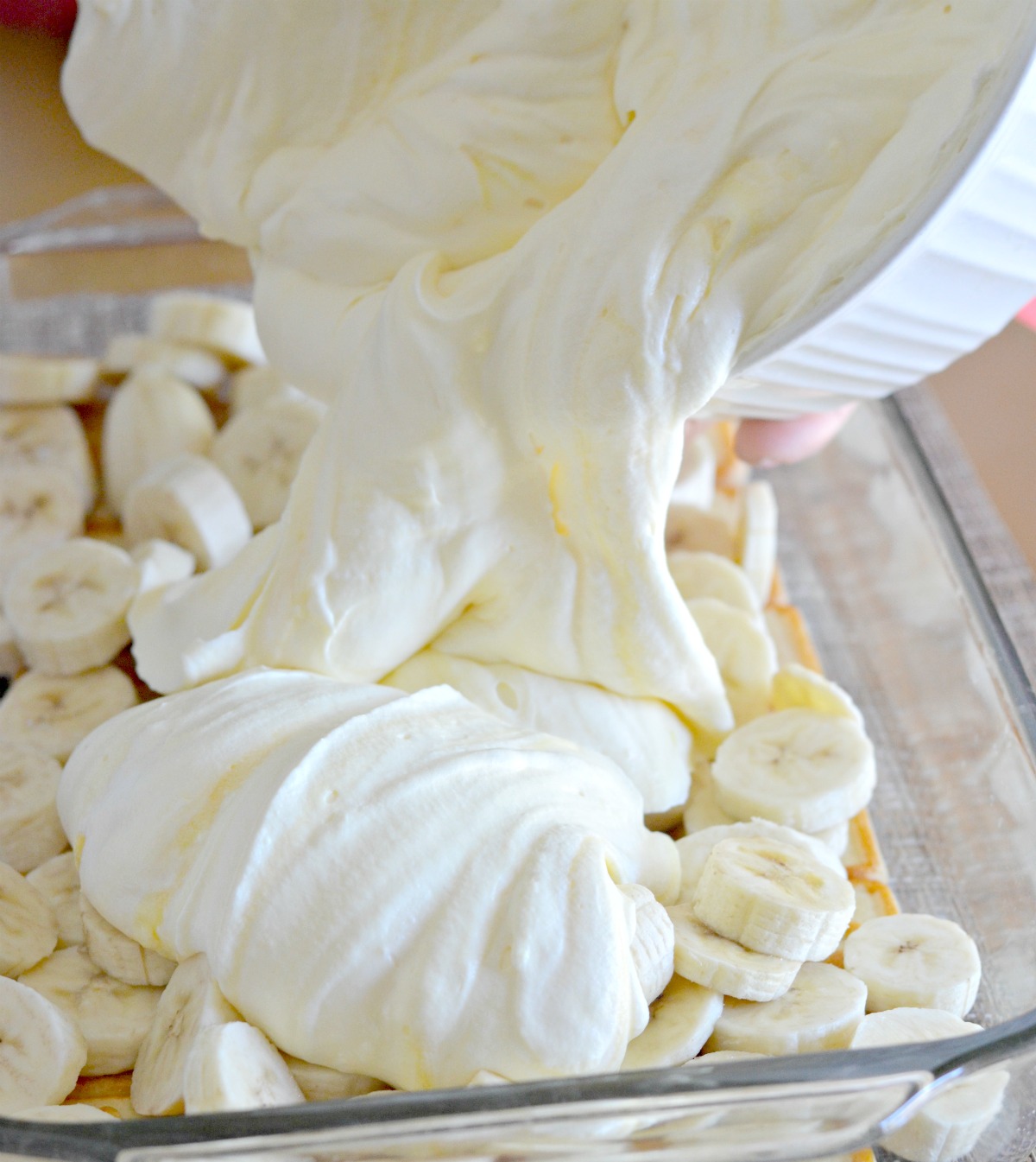 pouring the banana pudding into the pan