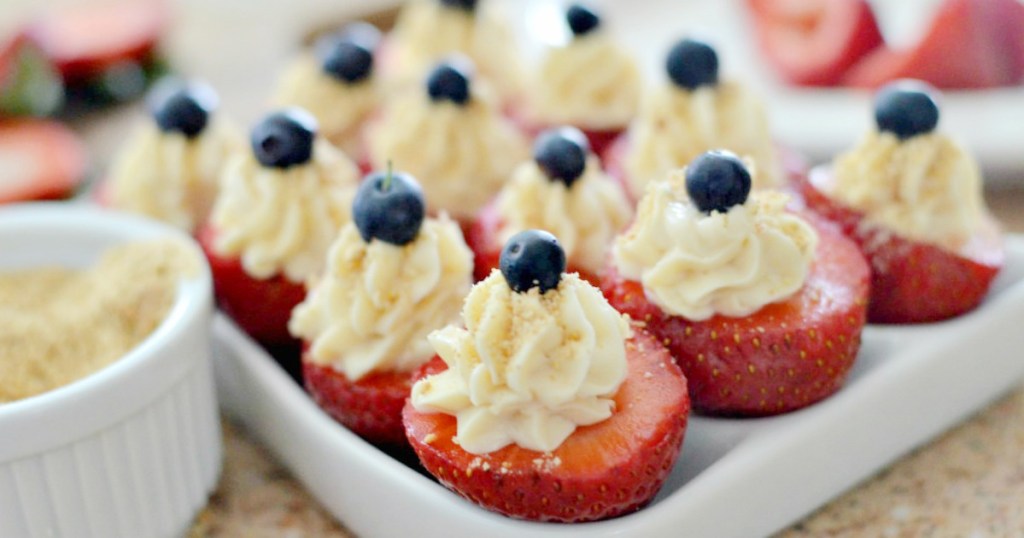 cheesecake stuffed strawberries on white tray