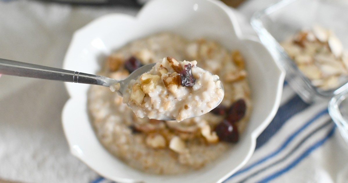 overnight oats cooking in crockpot with nuts in a white bowl