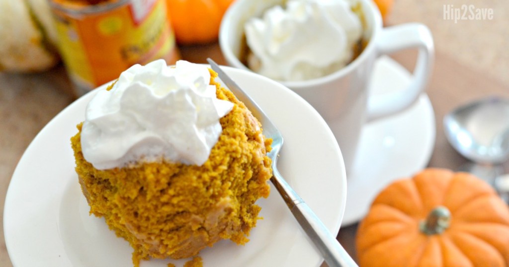 pumpkin mug cake on plate with whipped cream