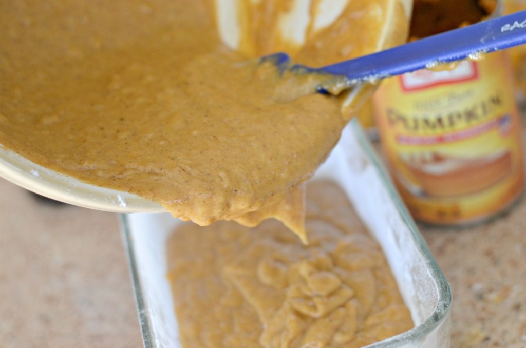 pouring pumpkin loaf batter into loaf pan