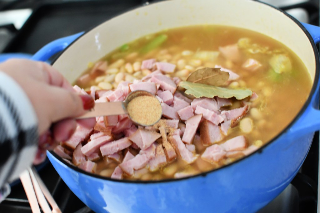 adding garlic to soup