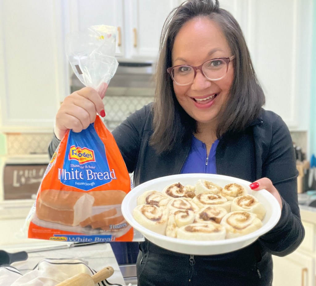 holding up frozen rhodes bread dough and cinnamon rolls in a pie pan