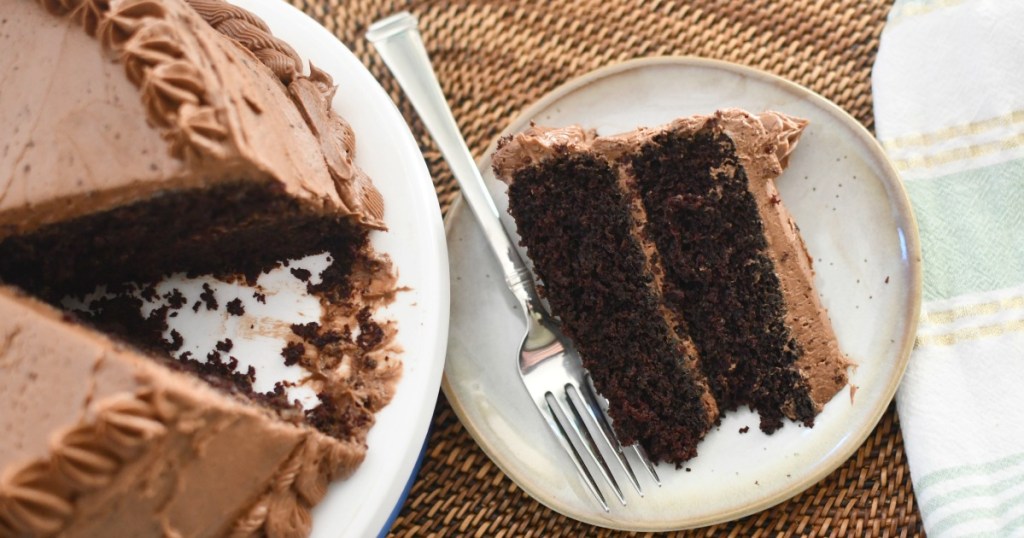 espresso cake slice on a small plate next to cake