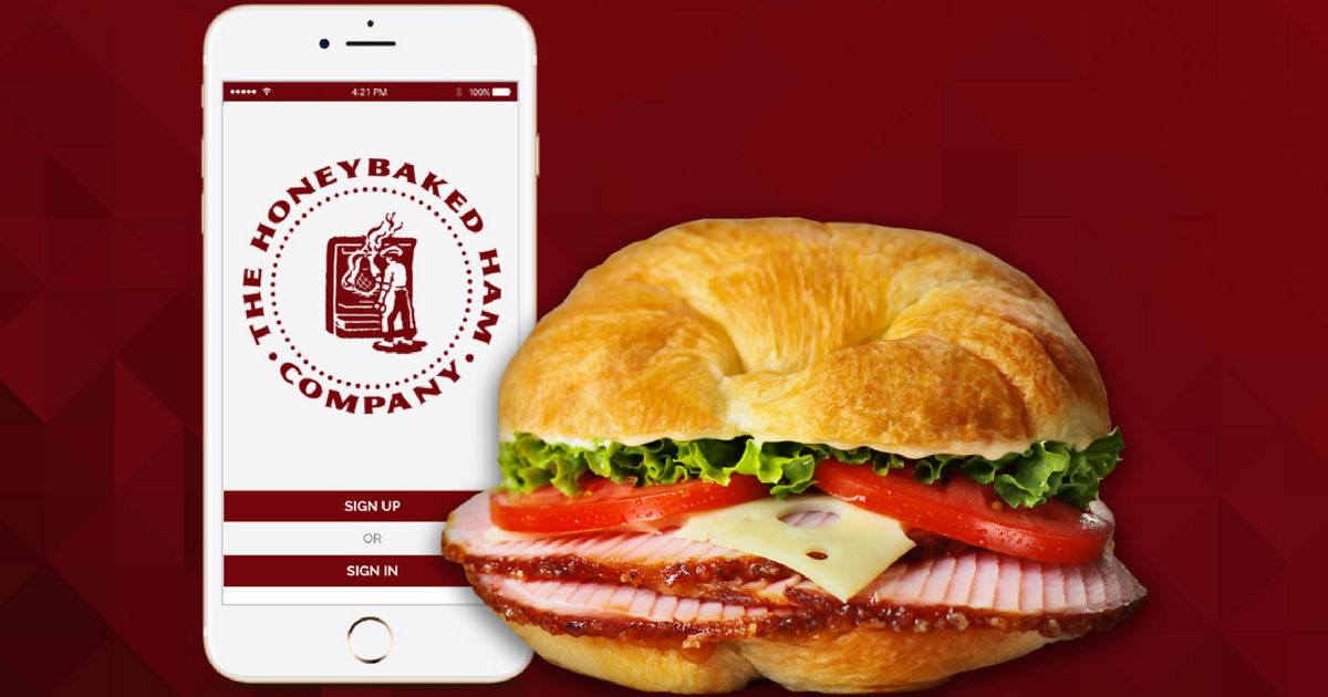 honeybaked ham app showing on smart phone next to sandwich