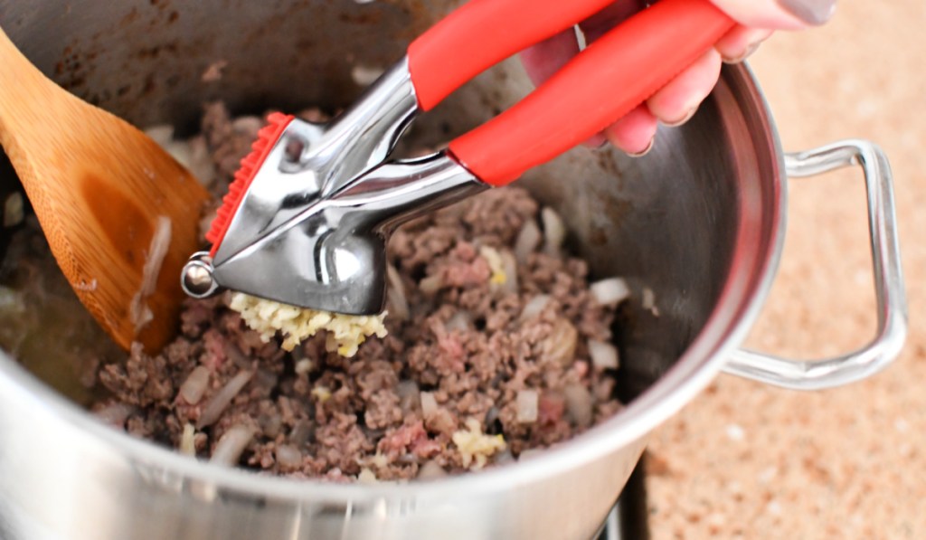 adding garlic to ground beef and onions