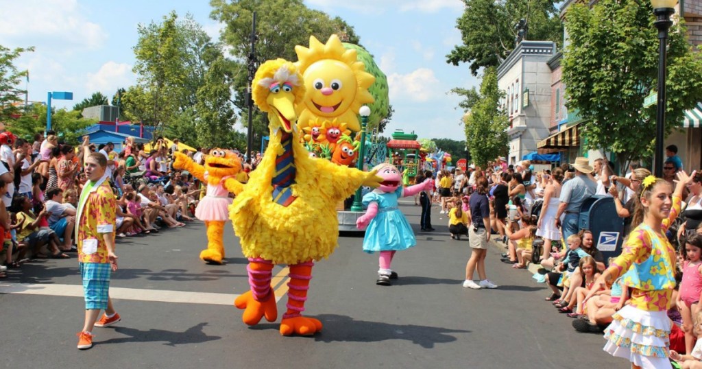 Kids walking in a parade with Big Bird
