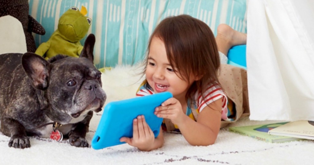 girl showing her dog a book