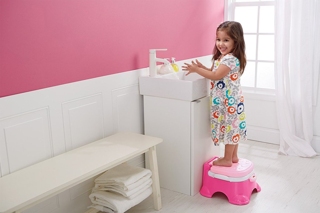 little girl washing hands at small sink