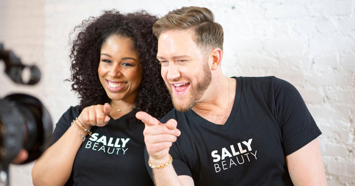 two people smiling wearing Sally Beauty Supply shirts