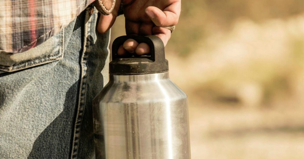 man holding dusty yeti rambler by the lid