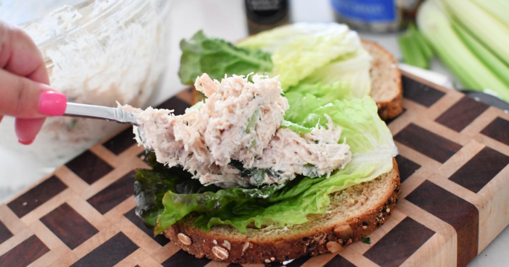 adding chicken salad to bread