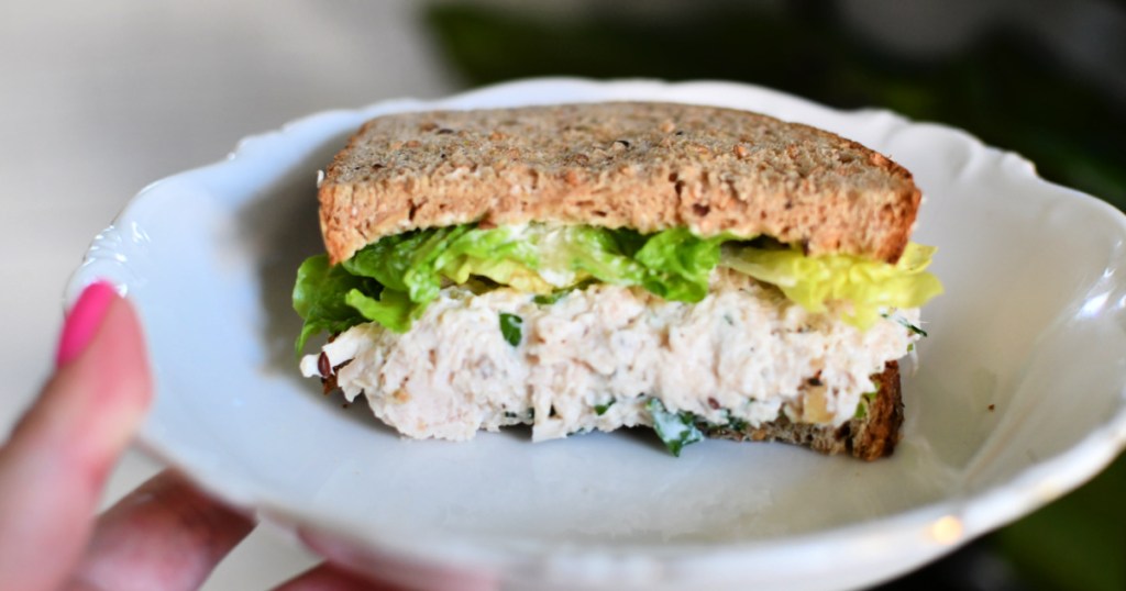 plate with half a chicken salad sandwich