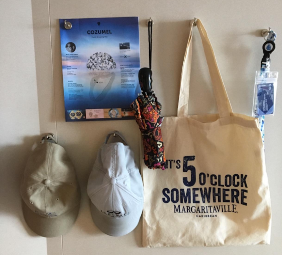 hats, paper, umbrellas, and bags hanging on wall 