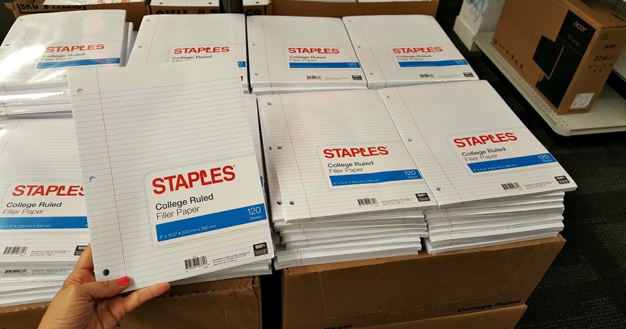 hand holding staples filler paper