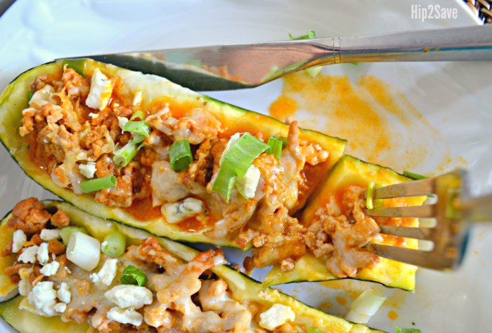 fork and knife cutting into buffalo chicken zucchini boat