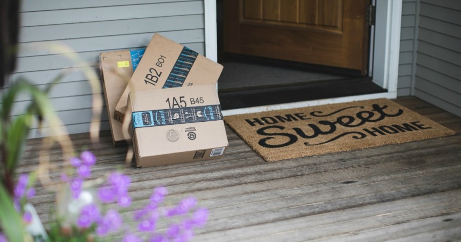 amazon boxes near front door and welcome mat
