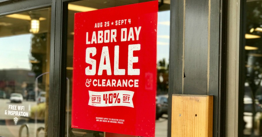 rei labor day sale sign in front of store - what to buy in september