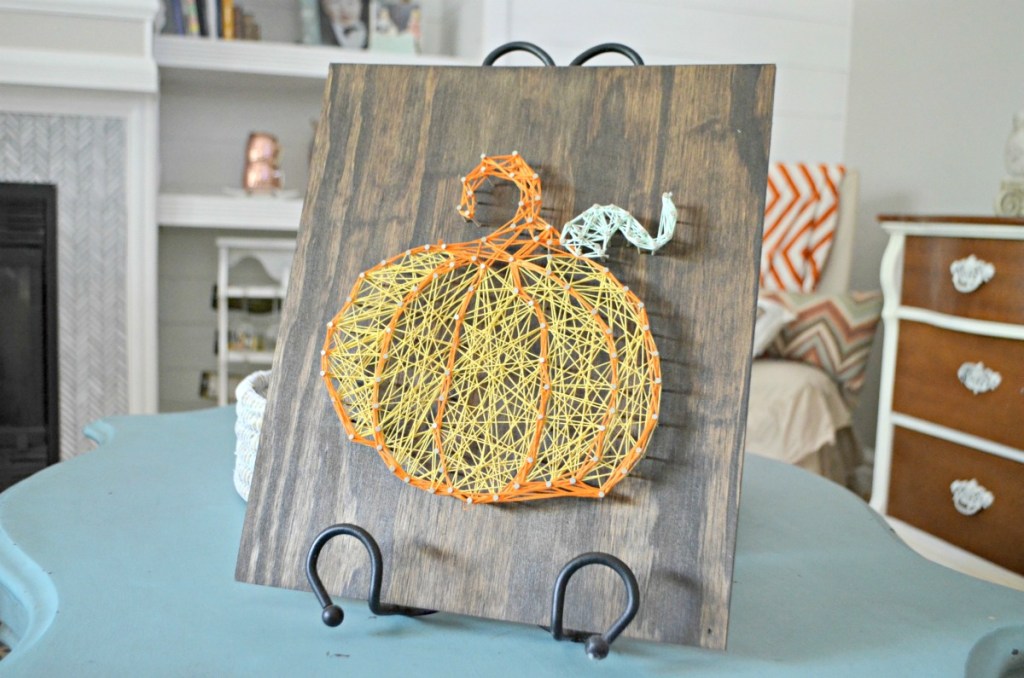 fall pumpkin string art on a table