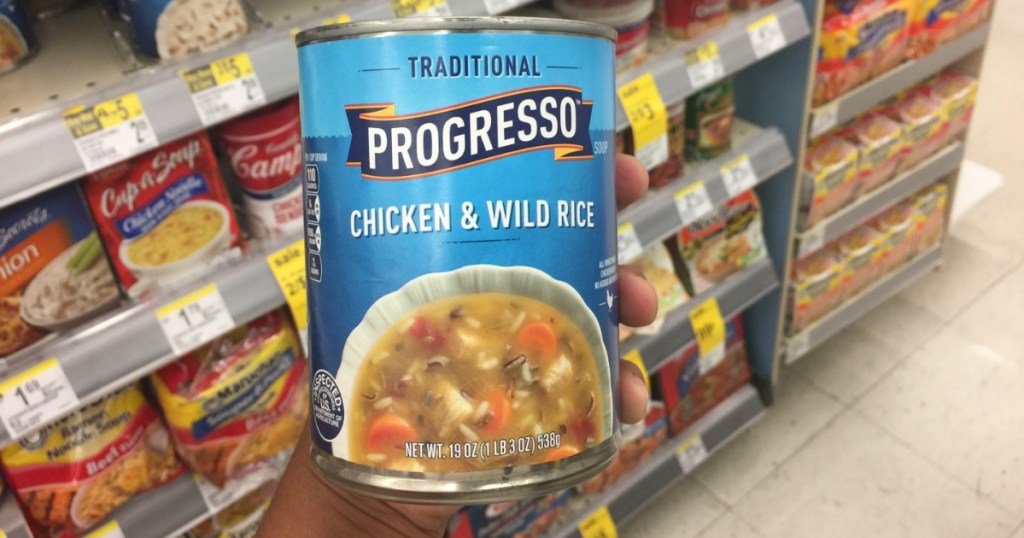 hand holding progresso chicken and wild rice soup can