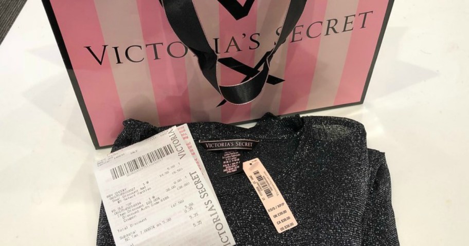 a victoria's secret bag with a shirt and receipt
