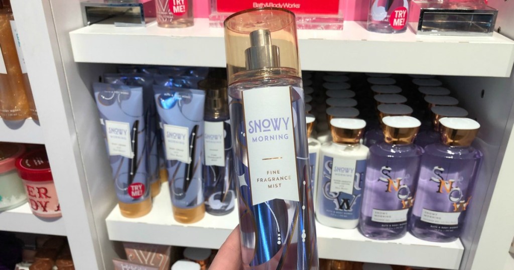 woman holding fragrance spray in-store