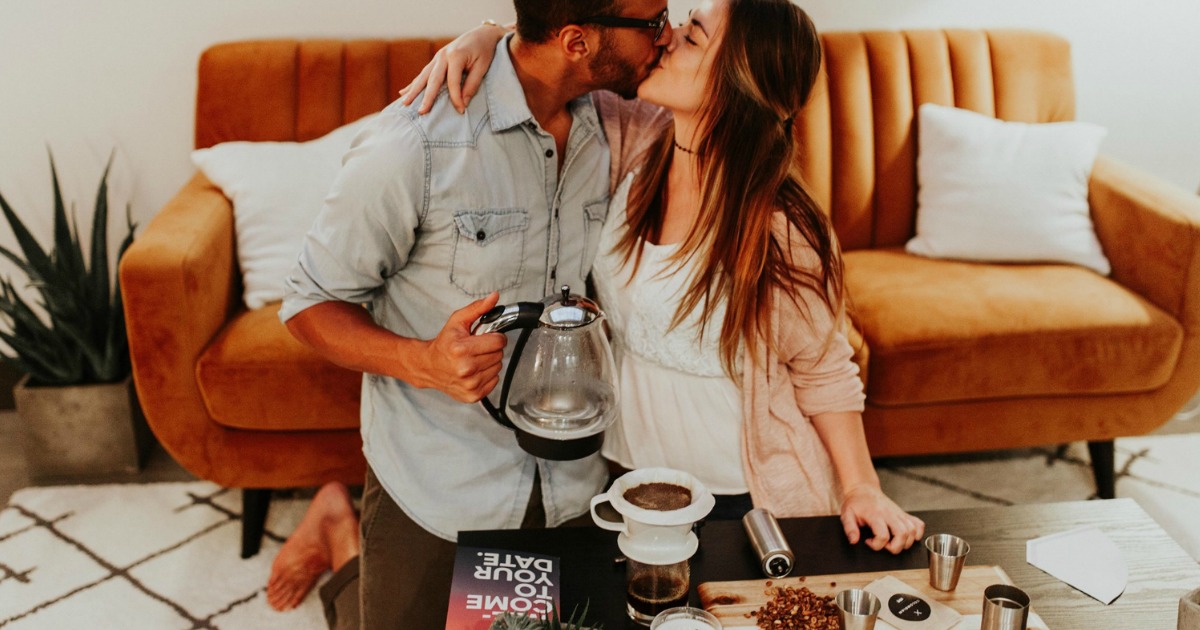 man and woman smiling and kissing