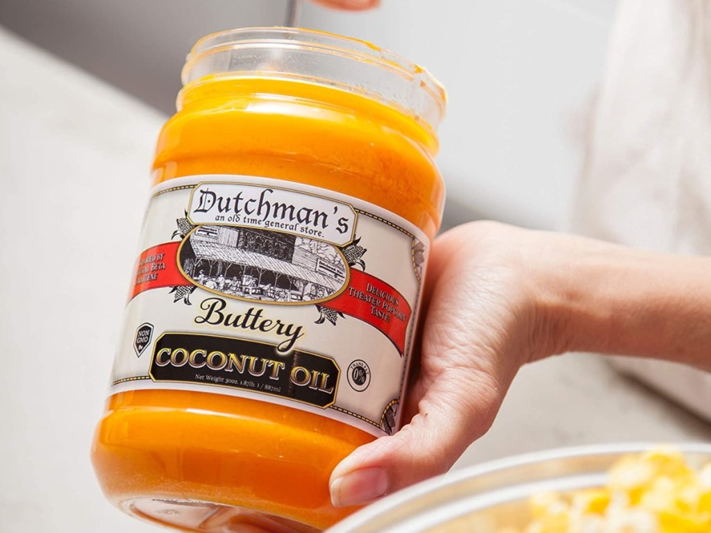 scooping butter-flavored coconut oil from jar