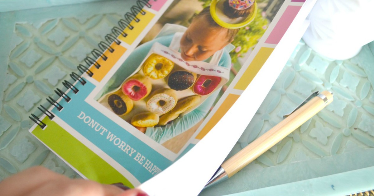 notebook with girl on cover and pen on a table