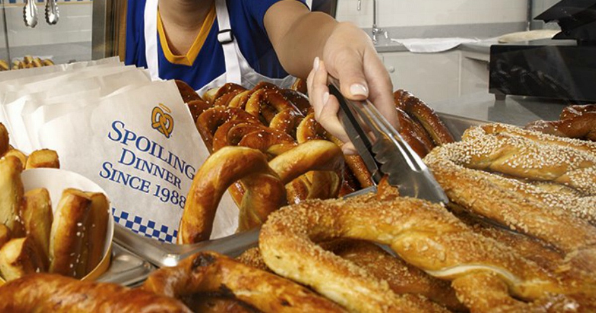 employee reaching in for an Auntie Anne's pretzel