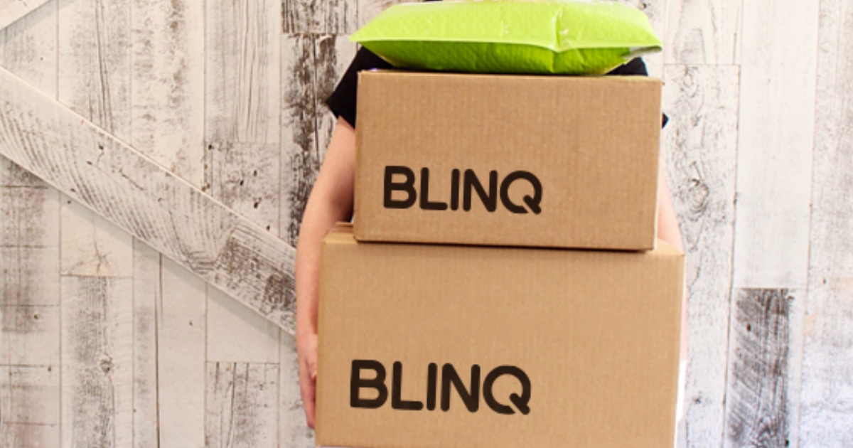 person holding Blinq boxes