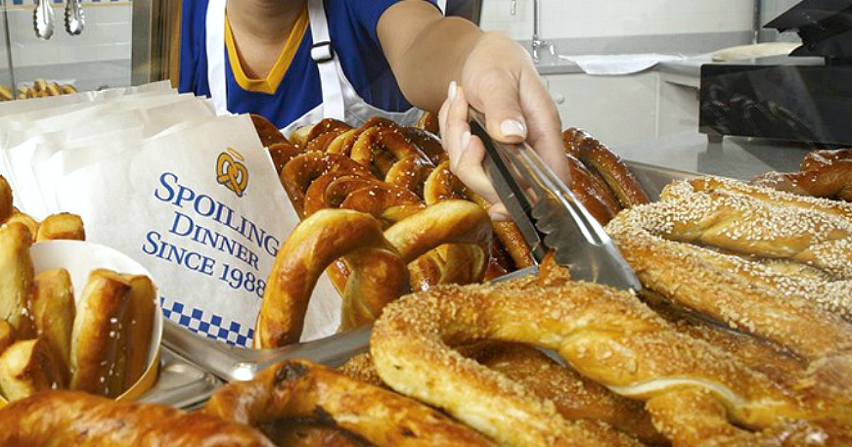 Get a FREE Auntie Anne's birthday pretzel - an Auntie Anne's employee reaching for a pretzel