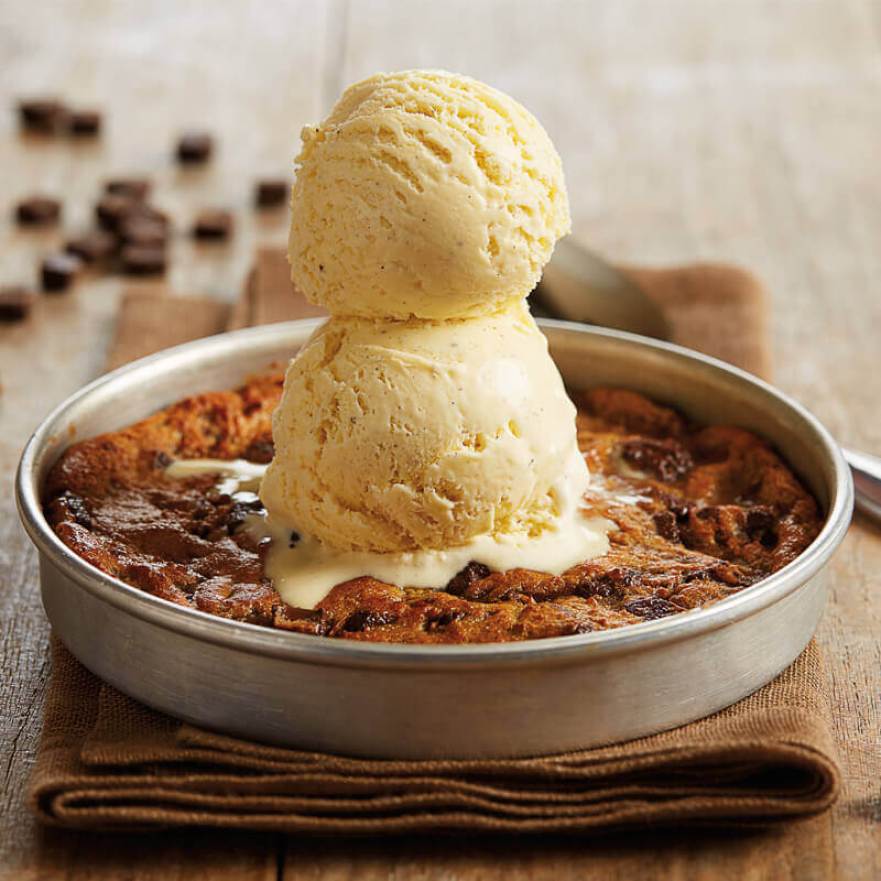 two scoops of ice cream on a bjs chocolate chip cookie