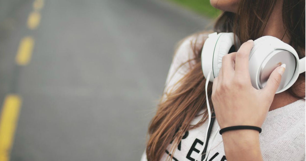 a young woman wearing white headphones