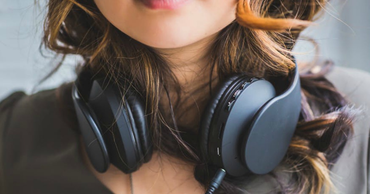 Woman with headphones around her neck