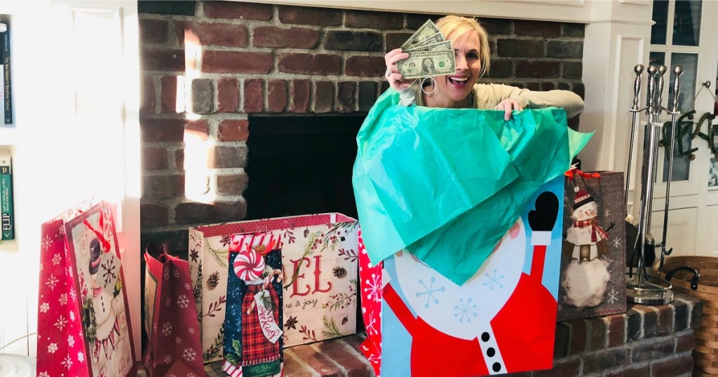 woman popping out of gift bag holding cash 