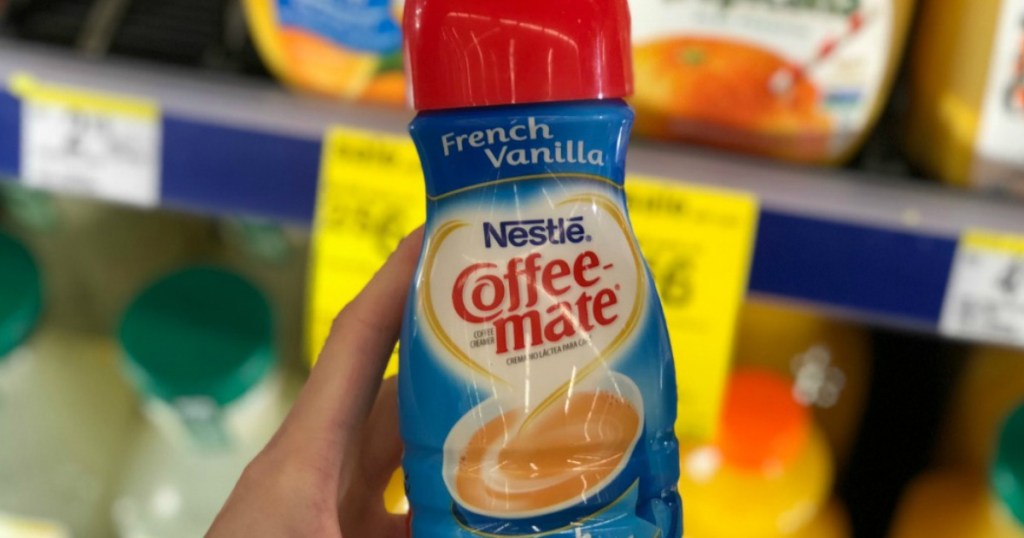 hand holding a bottle of coffee creamer in store